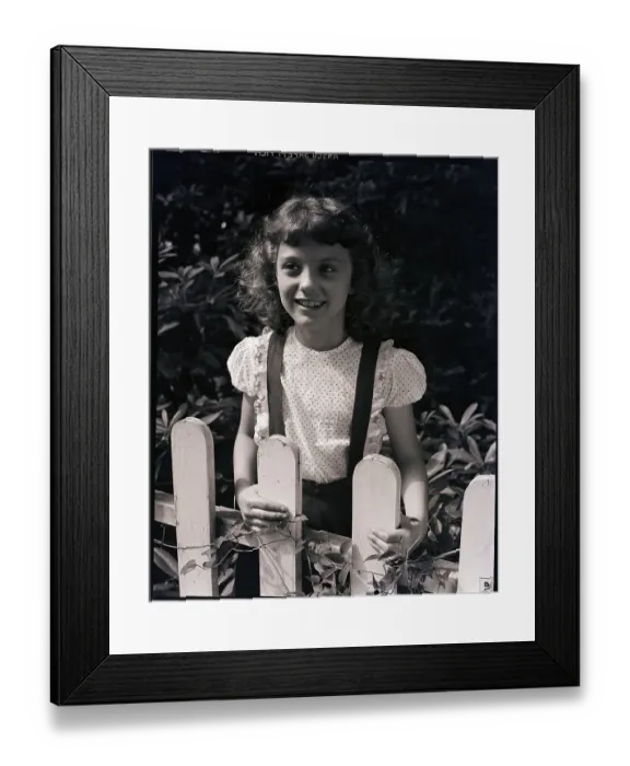 Framed Print : Girl Smiling Behind Fence Framed Print : Girl Smiling Behind Fence