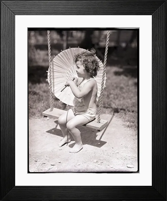 Framed Print : Girl on Swing Holding Parasol Framed Print : Girl on Swing Holding Parasol