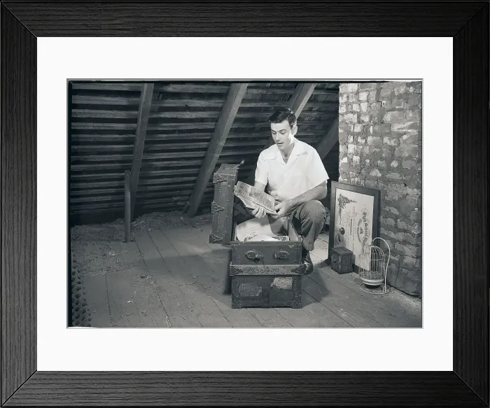 Framed Print : Man Looking at Papers in a Trunk Framed Print : Man Looking at Papers in a Trunk