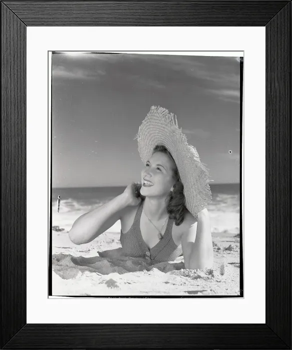 Framed Print : Woman Wearing Straw Hat Lying on Beach Framed Print : Woman Wearing Straw Hat Lying on Beach