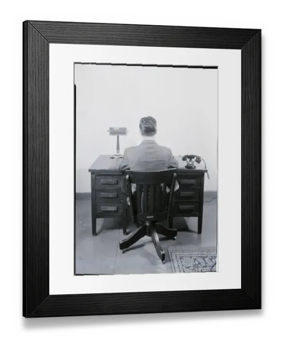 Framed Print : Businessman Sitting at a Desk Framed Print : Businessman Sitting at a Desk