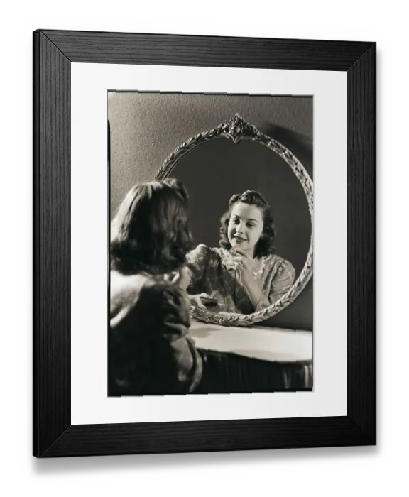 Framed Print : Young Woman Applying Cosmetics Framed Print : Young Woman Applying Cosmetics