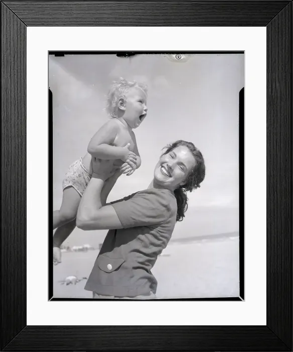 Framed Print : Mother Lifting Smiling Toddler at the Beach