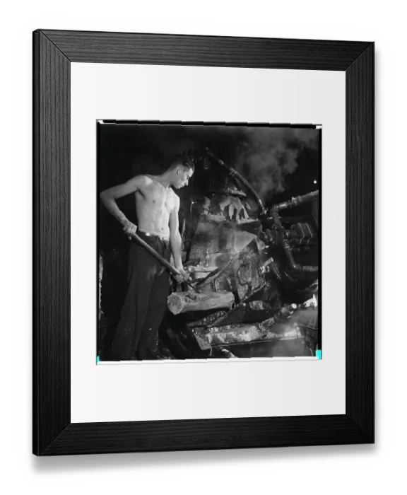 Framed Print : Man Placing Wood Into Machine Framed Print : Man Placing Wood Into Machine