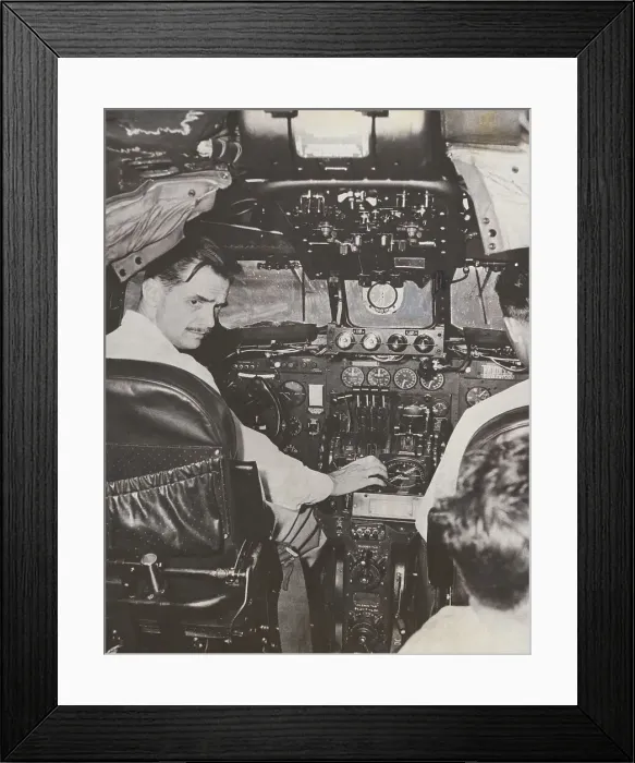 Framed Print : Howard Hughes at Plane Controls