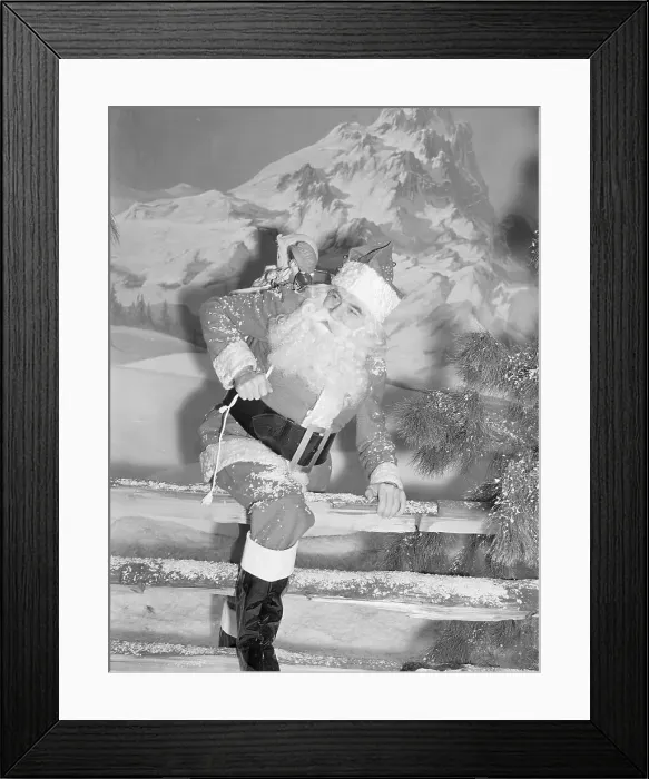 Framed Print : Bela Lugosi as Santa Climbing Over Fence Framed Print : Bela Lugosi as Santa Climbing Over Fence