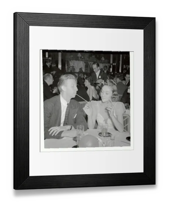 Framed Print : Edythe Wright Lighting Cigarette for Don Budge