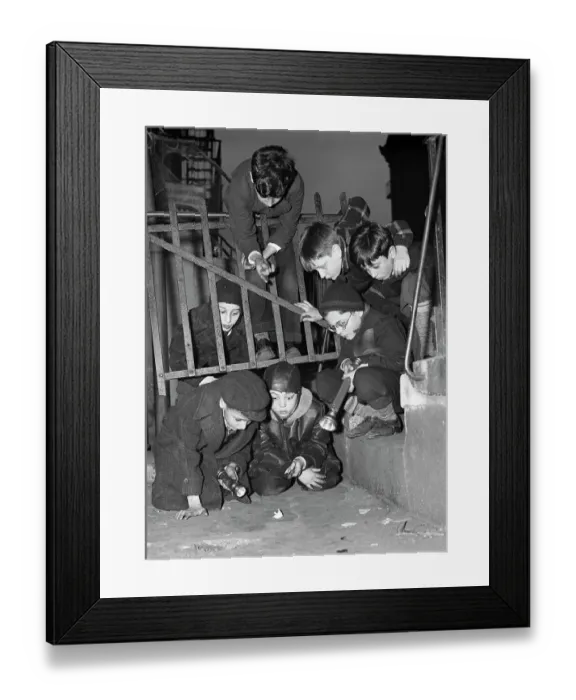 Framed Print : Boys Examine Paper on the Street Framed Print : Boys Examine Paper on the Street