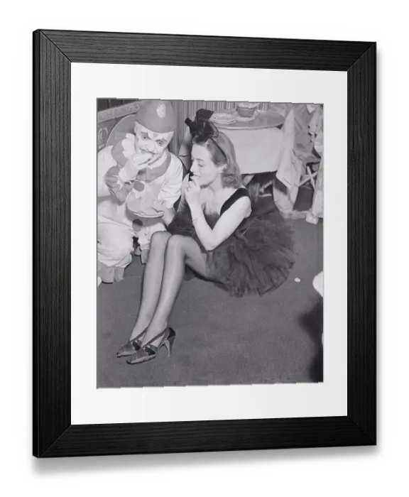 Framed Print : Joan Crawford Eating Cookie with Clown Framed Print : Joan Crawford Eating Cookie with Clown