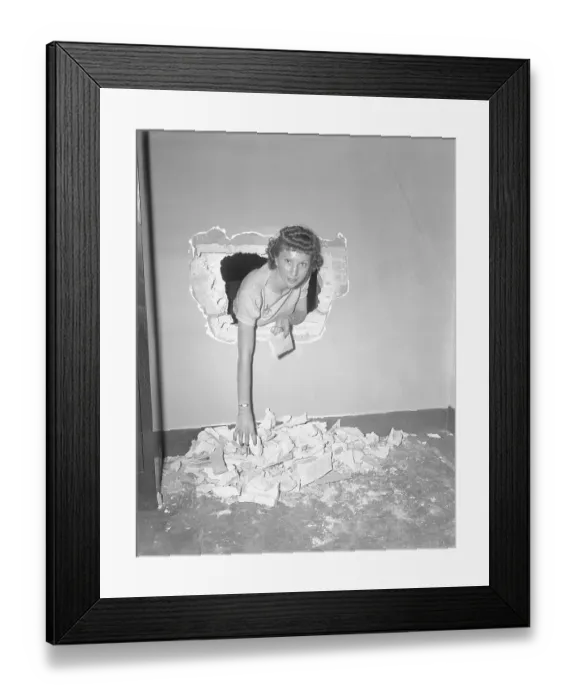 Framed Print : Woman Leaning Through Hole in Wall