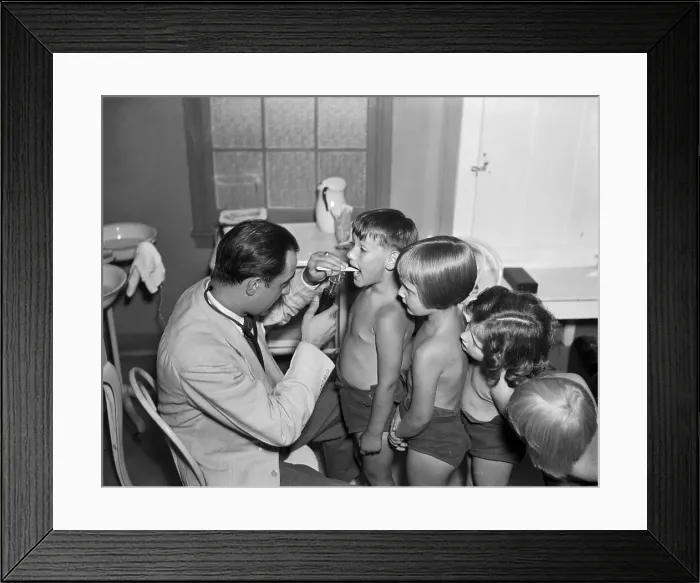 Framed Print : Doctor Checks Children For TB Symptoms Framed Print : Doctor Checks Children For TB Symptoms