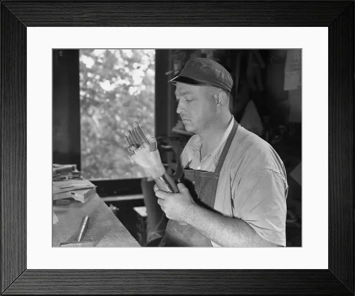 Framed Print : Technician Inspecting Artificial Hand Framed Print : Technician Inspecting Artificial Hand