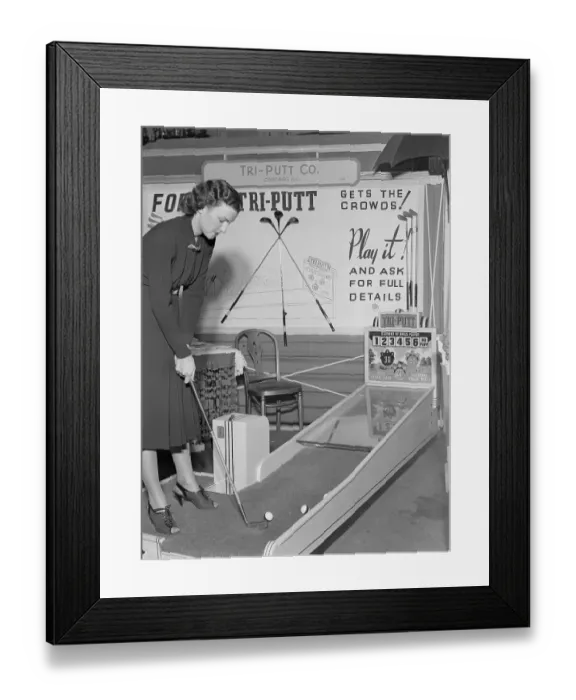 Framed Print : Young Woman Aiming Golf Club at Game Exhibit Framed Print : Young Woman Aiming Golf Club at Game Exhibit