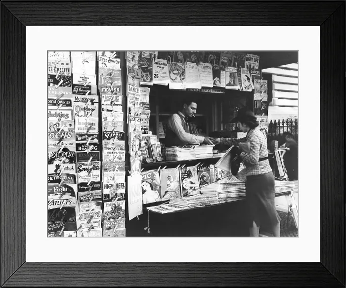Framed Print : Woman Buys Magazine at Newsstand