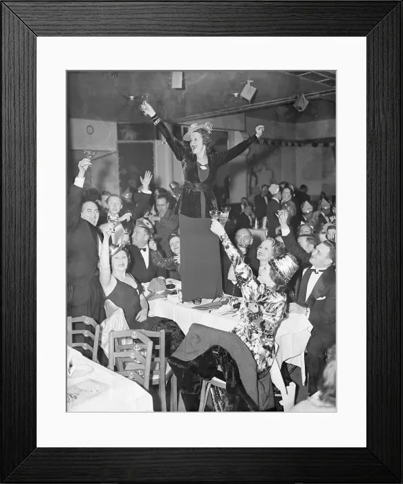 Framed Print : Woman Standing on Table Toasting the New Year Framed Print : Woman Standing on Table Toasting the New Year