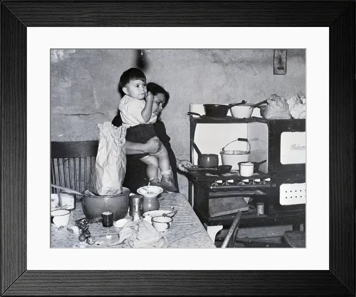 Framed Print : Woman Holds Child While Cooking;Poverty Framed Print : Woman Holds Child While Cooking;Poverty