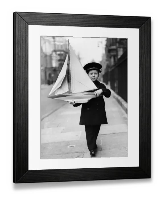 Framed Print : Boy with Toy Sailboat