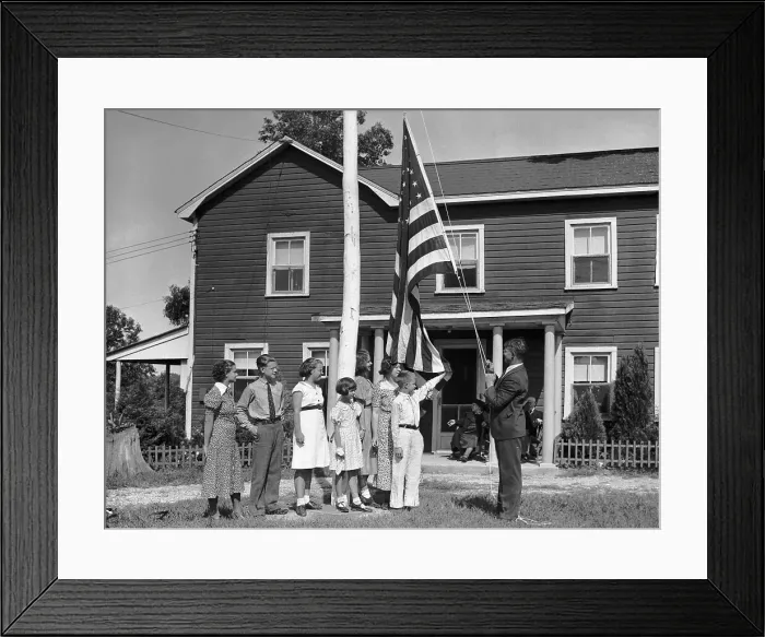 Framed Print : Family Raising Flag Outside Home Framed Print : Family Raising Flag Outside Home