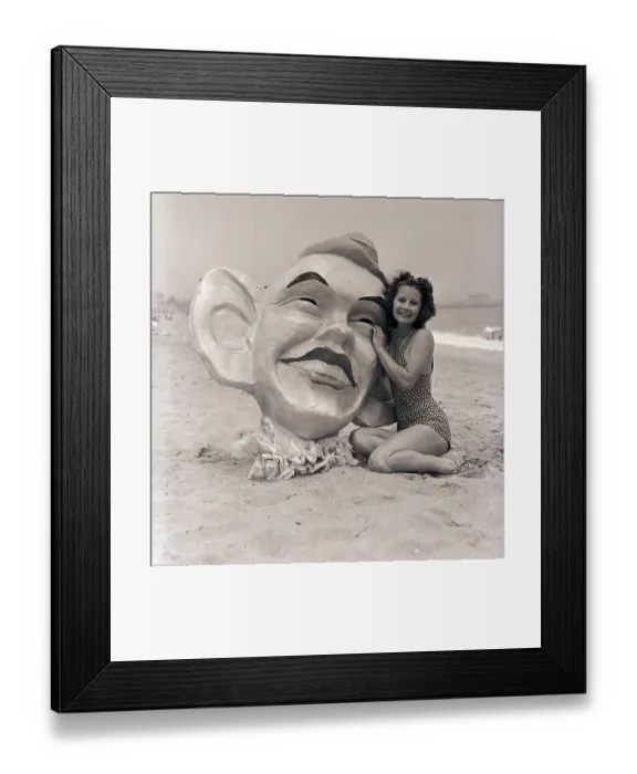 Framed Print : Woman Poses with Huge Mask on Beach Framed Print : Woman Poses with Huge Mask on Beach