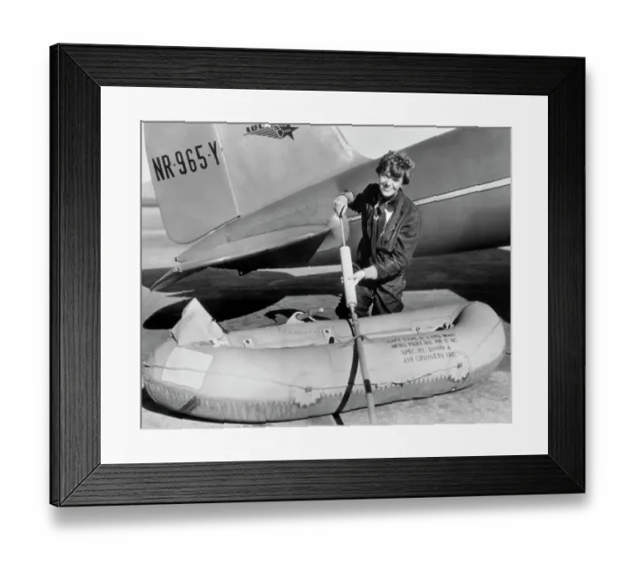 Framed Print : Amelia Earhart Working on Raft Besides Airplane