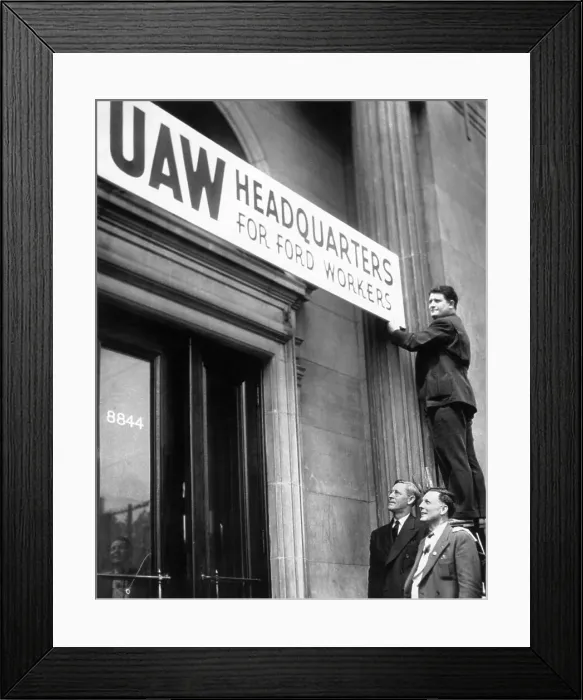 Framed Print : Man Stands Atop Ladder To Hang Sign Framed Print : Man Stands Atop Ladder To Hang Sign