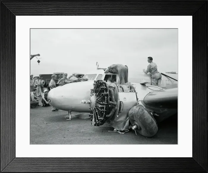 Framed Print : Workers Examining Amelia Earhart's Airplane for Engine Problems Framed Print : Workers Examining Amelia Earhart's Airplane for Engine Problems