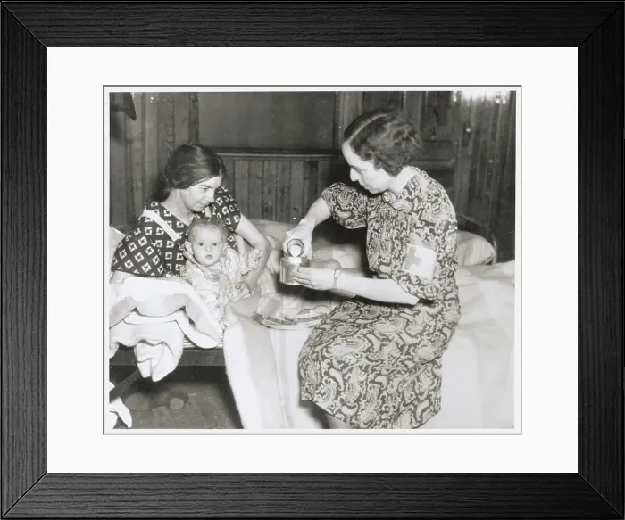 Framed Print : Red Cross Worker Serving Milk Framed Print : Red Cross Worker Serving Milk