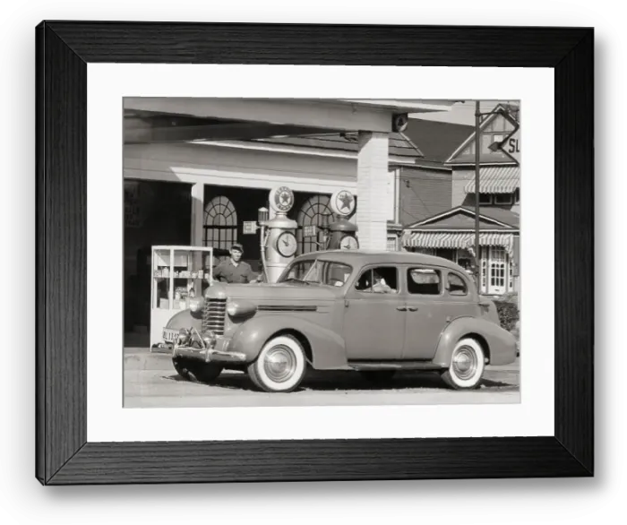 Framed Print : Gas Attendant Holding Gas Pump