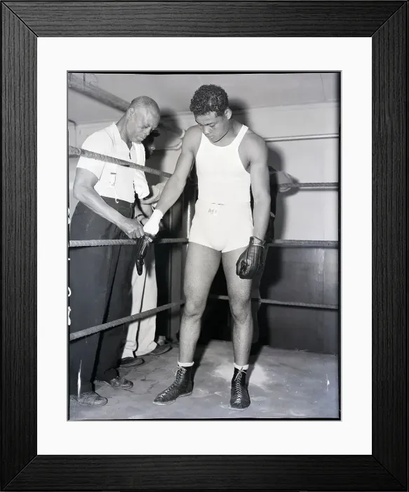 Framed Print : Trainer Putting Gloves on Joe Louis Framed Print : Trainer Putting Gloves on Joe Louis