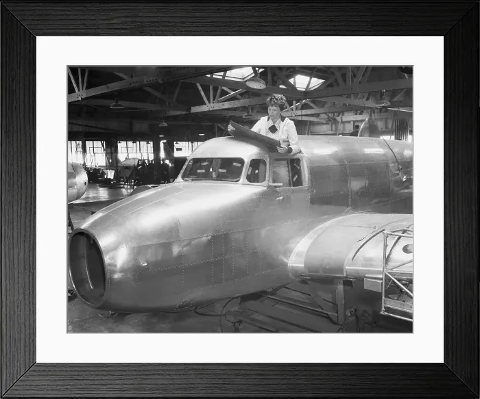 Framed Print : Amelia Earhart Reading Blueprints in Cockpit Framed Print : Amelia Earhart Reading Blueprints in Cockpit