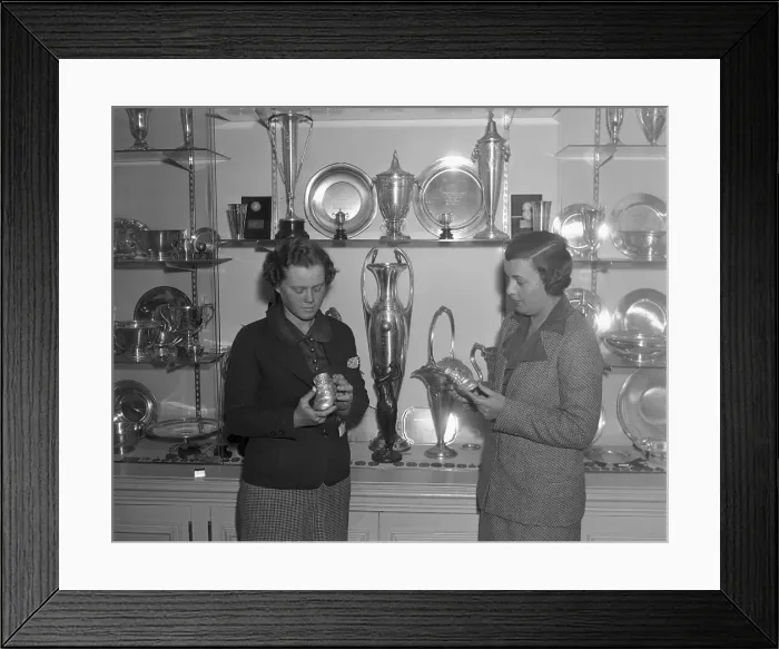 Framed Print : Woman Golfers Looking at Trophies Framed Print : Woman Golfers Looking at Trophies