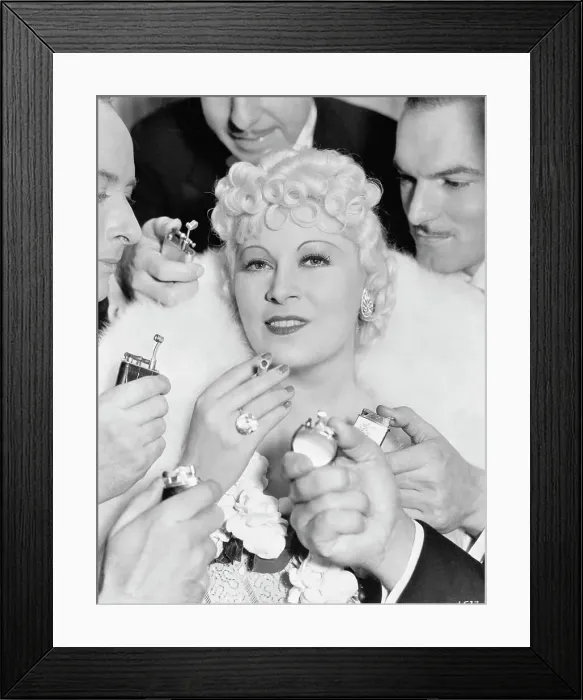 Framed Print : Men Offering to Light Cigarette for Mae West Framed Print : Men Offering to Light Cigarette for Mae West