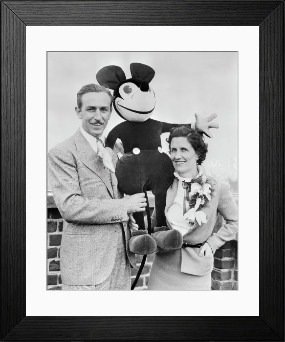 Framed Print : Walt and Mrs. Disney Standing with Stuffed Mickey Mouse Framed Print : Walt and Mrs. Disney Standing with Stuffed Mickey Mouse