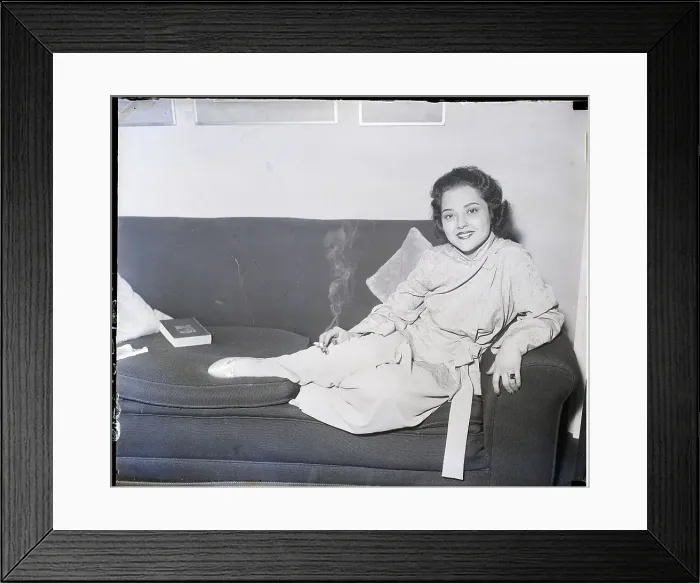 Framed Print : Miriam Battista Seated on Couch Smoking Framed Print : Miriam Battista Seated on Couch Smoking