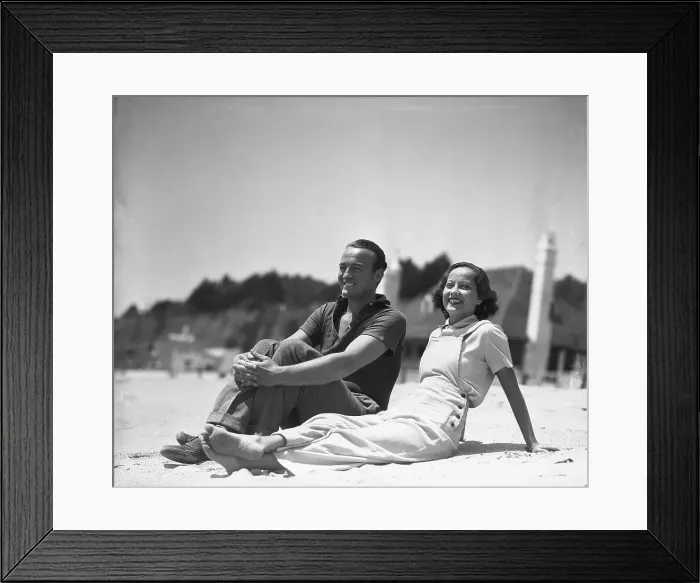 Framed Print : David Niven and Merle Oberon Relaxing at the Beach Framed Print : David Niven and Merle Oberon Relaxing at the Beach
