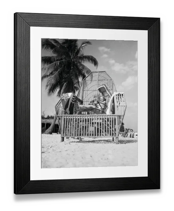 Framed Print : Tez Jackson Sitting in a Large Reed Chair