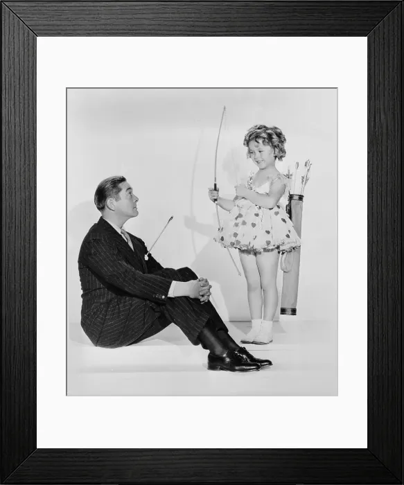 Framed Print : Shirley Temple Holding Bow With Jimmy Dunn Framed Print : Shirley Temple Holding Bow With Jimmy Dunn
