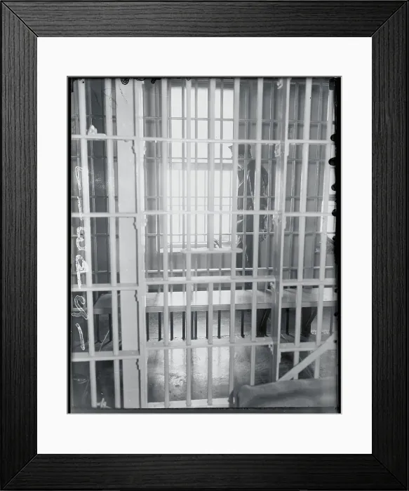 Framed Print : Guard as Seen Outside Jail Bars