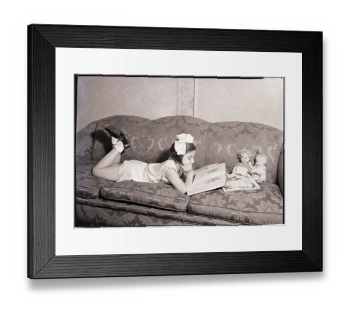 Framed Print : Girl Reading on Sofa Framed Print : Girl Reading on Sofa