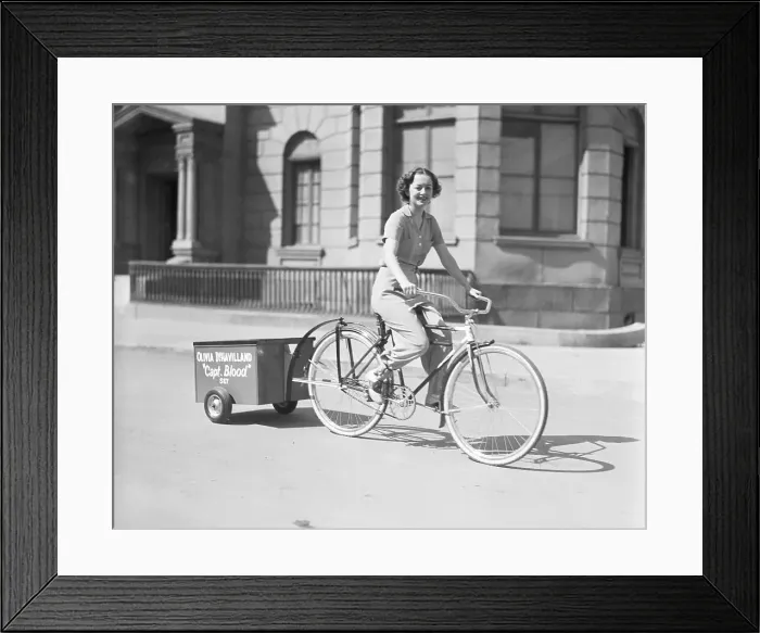 Framed Print : Olivia De Havilland Riding Bicycle Framed Print : Olivia De Havilland Riding Bicycle