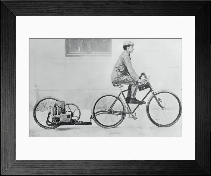Framed Print : Man Riding Bicycle Being Propelled by Engine Framed Print : Man Riding Bicycle Being Propelled by Engine