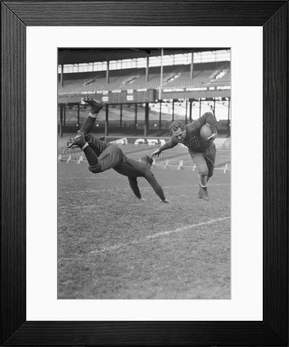 Framed Print : Red Grange Dodging Tackle