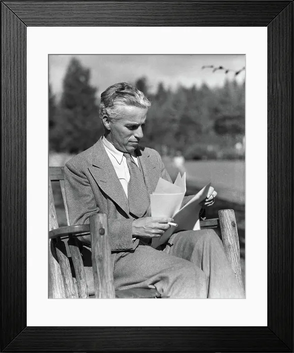 Framed Print : Charlie Chaplin Reads Script Outside Framed Print : Charlie Chaplin Reads Script Outside