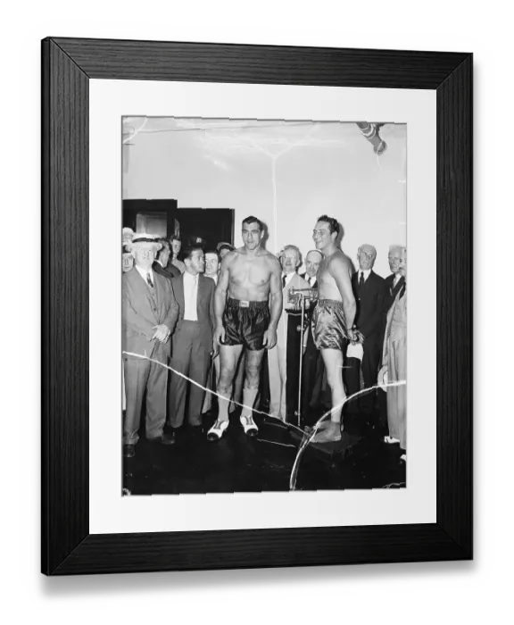 Framed Print : Boxer Max Baer Weighs In as Boxer Primo Carnera Watches Framed Print : Boxer Max Baer Weighs In as Boxer Primo Carnera Watches
