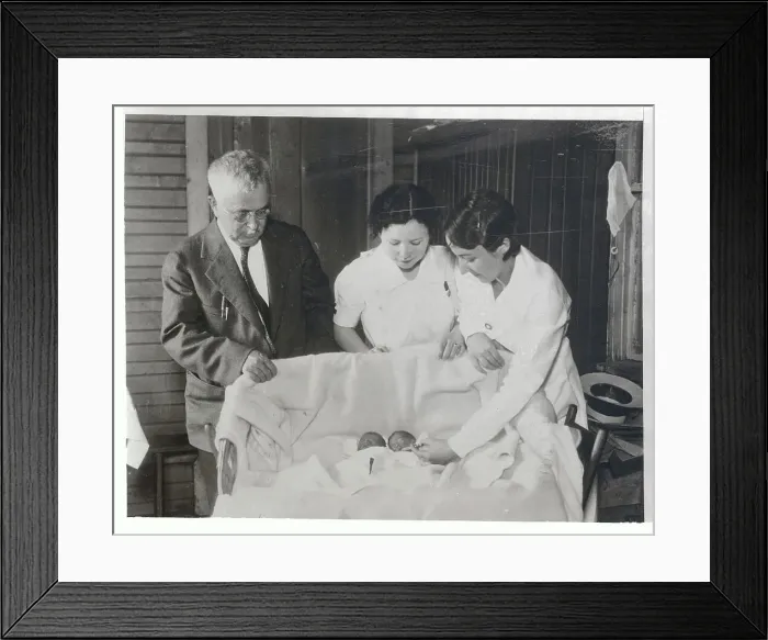 Framed Print : Nurses and Doctor Viewing Infants Lying Together Framed Print : Nurses and Doctor Viewing Infants Lying Together