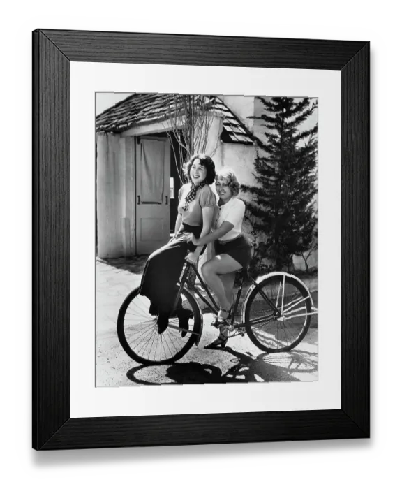 Framed Print : Joan Blondell and Sister Riding Bicycle Framed Print : Joan Blondell and Sister Riding Bicycle