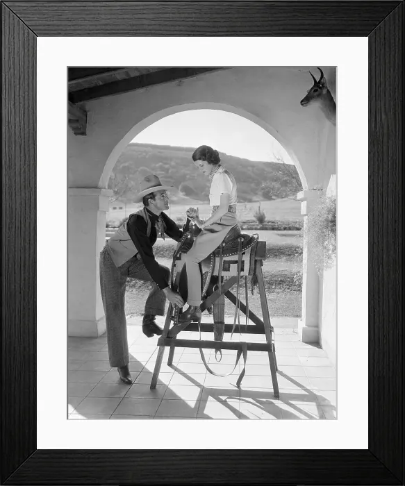 Framed Print : Gary Cooper Teaching His Wife How to Use a Saddle Framed Print : Gary Cooper Teaching His Wife How to Use a Saddle