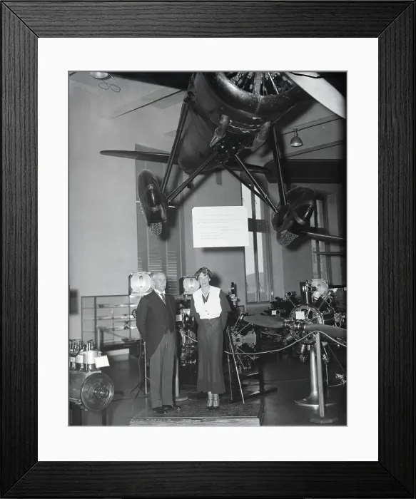 Framed Print : Amelia Earhart and Orville Wright Posing Near Displayed Airplane Framed Print : Amelia Earhart and Orville Wright Posing Near Displayed Airplane