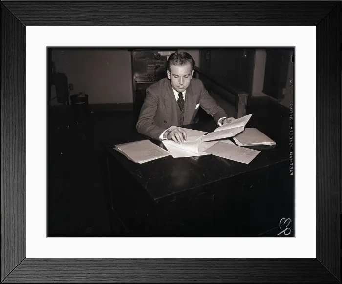 Framed Print : Young Man at Desk Preparing a Report