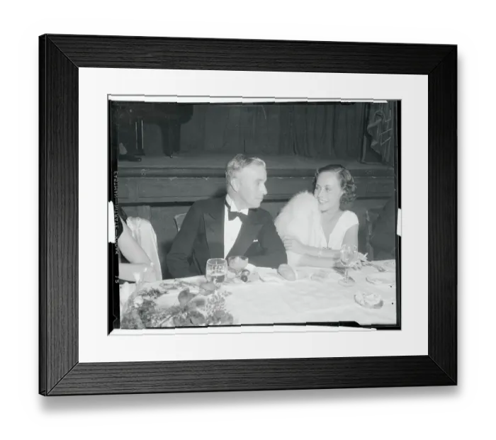 Framed Print : Charlie Chaplin Chatting with Paulette Goddard
